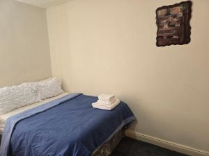 a bedroom with a bed with two towels on it at Realwood Homes- Birrell Road in Nottingham +23 photos