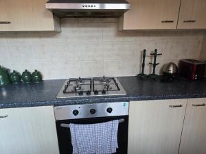 a kitchen with a stove and a sink at Realwood Homes- Birrell Road in Nottingham