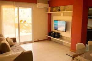 a living room with a couch and a television at Centrico-Terraza c/Parrilla -AA y lavarropas in Mendoza