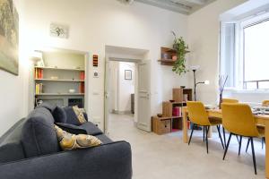 a living room with a couch and a table at Elegantis Trastevere Modern Apartment - Comfort in Rome Most Charming District in Rome