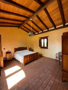 a bedroom with a bed and a wooden ceiling at Agriturismo Tenute Spartà in Randazzo