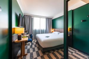 Postel nebo postele na pokoji v ubytování Hotel Le Lumière