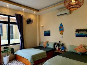 a room with two beds and a window at Sông Suối homestay 2 in Quy Nhon
