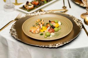 a plate of food on top of a table at Holiday Inn Abu Dhabi by IHG in Abu Dhabi