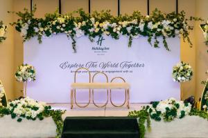 a stage with a chair and flowers on it at Holiday Inn Abu Dhabi by IHG in Abu Dhabi