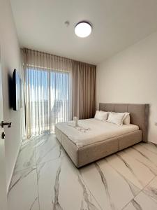a bedroom with a bed and a large window at Penthouse-AH- 77 in Eilat