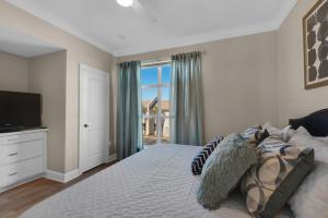 a bedroom with a large bed with a television at Bikini Bottom by Gulf Coast Getaways in Navarre +39 photos