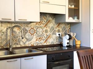a kitchen with a sink and a counter top at Villa Leandra in Fontane Bianche