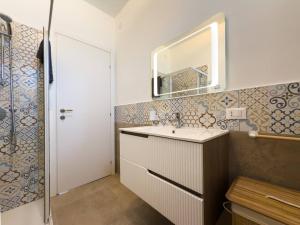 a bathroom with a sink and a mirror at Villa Leandra in Fontane Bianche