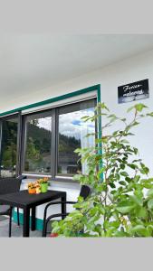 a room with a table and a large window at Ferienwohnung am Meulenwald in Föhren +3 photos