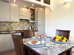 a kitchen with a table with plates of food on it at Villa Leandra in Fontane Bianche