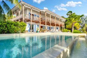 a house with a swimming pool in front of it at Villa Shores 32 in Kralendijk