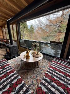 a room with a table and a large window at Ayder Villa Gencal in Ayder Yaylasi