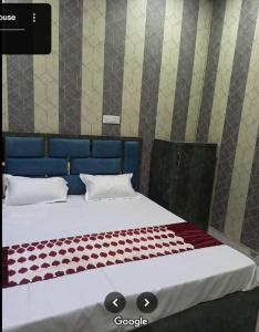 two twin beds in a room with at Captain Guesthouse in Mathura