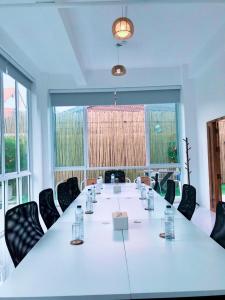 a large meeting room with a long table and chairs at J-Boutique Hotel เจ-บูทีค โฮเทล in Khon Kaen +110 photos