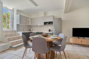 a kitchen and dining room with a wooden table and chairs at Casa Sparto in Meganisi