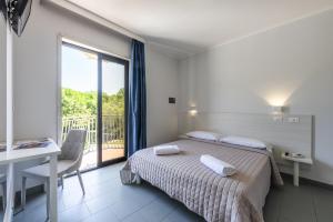 Posteľ alebo postele v izbe v ubytovaní Hotel La Siesta