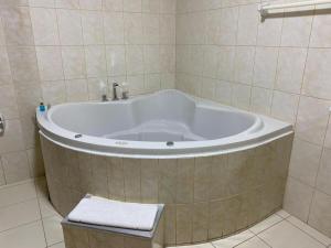 a bath tub in a bathroom with a sink at Hotel INTERnazionale in Ayacucho