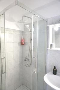 a shower with a glass door in a bathroom at Ionian Blue Studio in Preveza