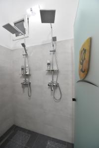 a bathroom with a shower with lights on the wall at BLISS HOUSE Primariei in Oradea +14 photos