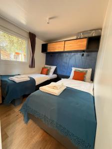 a room with two beds and a window at George Holiday Homes - Soline Beach in Biograd na Moru