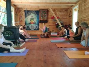 a group of people sitting in a room doing yoga at Bakasana in Ruciane-Nida