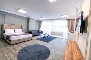 Ένα ή περισσότερα κρεβάτια σε δωμάτιο στο Royal Luxury Hotels Suites