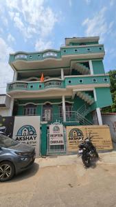 a car parked in front of a green building at Akshay BnB & HomeStay in Lucknow