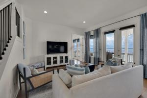 a living room with a couch and chairs and a tv at Lets Do Sunset by Gulf Coast Getaways in Pensacola Beach