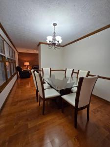 a dining room with a glass table and chairs at Metro Atlanta 3bed 2 Bath House in Stone Mountain