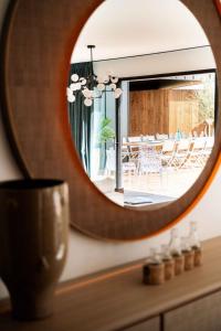 a mirror on a dresser in a room with a table at Villa Loire Harmony in Ancenis +48 photos
