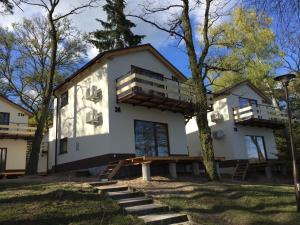 a house with a deck on the side of it at Zielony Cypel in Lubniewice