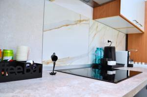 a kitchen with a counter with a glass counter top at Mid Centro Residence, Self check in & out in Oradea +30 photos