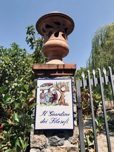 a sign attached to a fence with a street light at Il Giardino dei Filosofi in Ascea