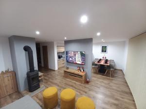 a living room with a wood stove and a table at Chata Junáčik Oravice in Oravice