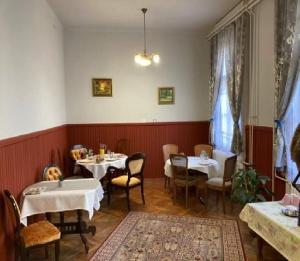 a restaurant with tables and chairs in a room at Meller-kastély Villa in Csurgó