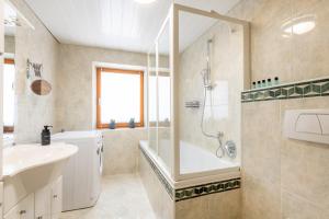 a bathroom with a shower and a sink at Apartmenthaus Achener Hof in Ehrwald