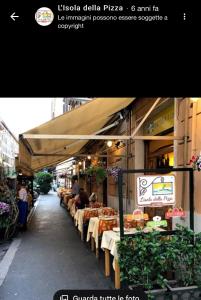 a restaurant with tables and chairs on a street at Vatican Attic in Rome