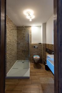 a bathroom with a shower and a toilet and a sink at Meller-kastély Villa in Csurgó
