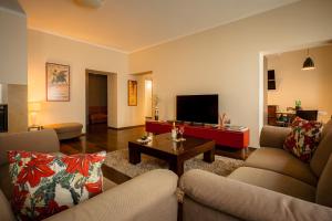 a living room with two couches and a coffee table at Piotrkowska 89 Residence in Łódź