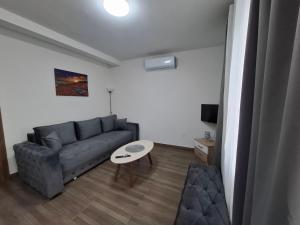 a living room with a couch and a table at Apartman Lazovic Prcanj in Kotor