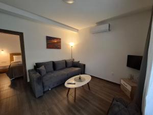 a living room with a couch and a table at Apartman Lazovic Prcanj in Kotor