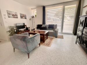 a living room with a couch and a table at Les Sardinières in Le Relecq-Kerhuon