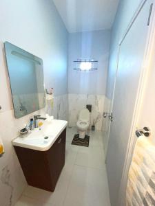a bathroom with a sink and a toilet at Appartement avec Rooftop privé et Jacuzzi in Albion +33 photos