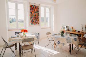 a dining room with two tables and chairs at Logis de Vallombronze in Clérac