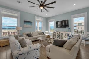 a living room with two couches and a tv at Peachy Queen by Gulf Coast Getaways in Navarre