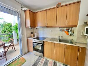 a kitchen with wooden cabinets and a sink at Nikiti Azzurro villa in Nikiti