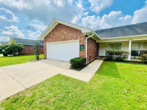 a brick house with a white garage at Eastgate 17A beautiful townhouse in Hammond