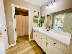 a bathroom with a sink and a large mirror at Eastgate 17A beautiful townhouse in Hammond +37 photos