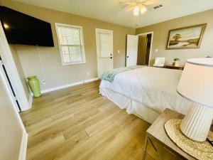 a bedroom with a bed and a flat screen tv at Eastgate 17A beautiful townhouse in Hammond